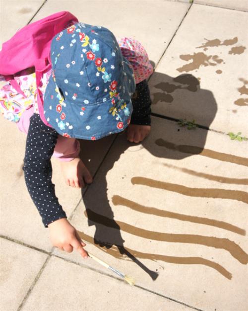 Child painting with water